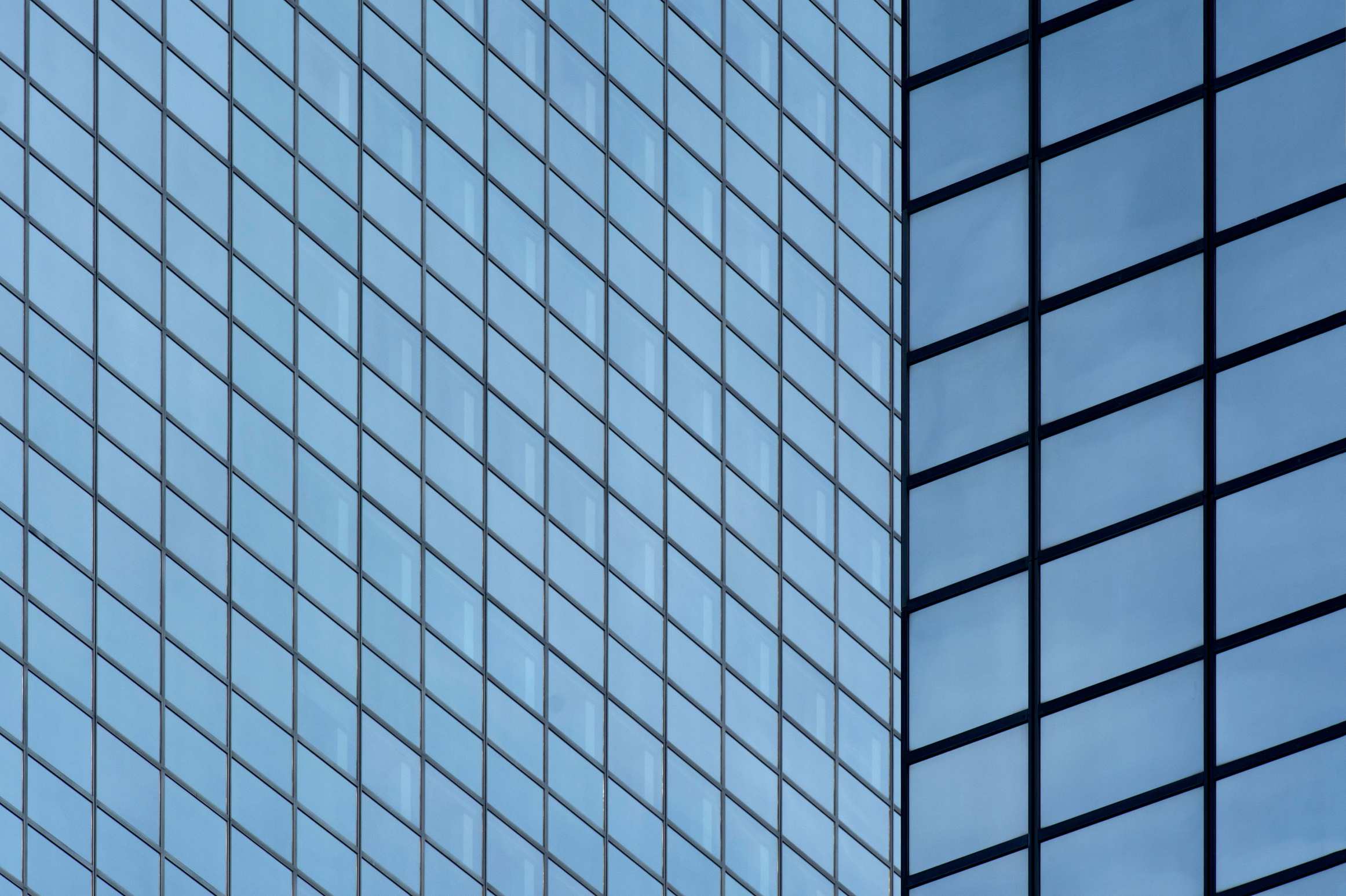Detailed view of a modern glass skyscraper facade showing repetition and urban architecture