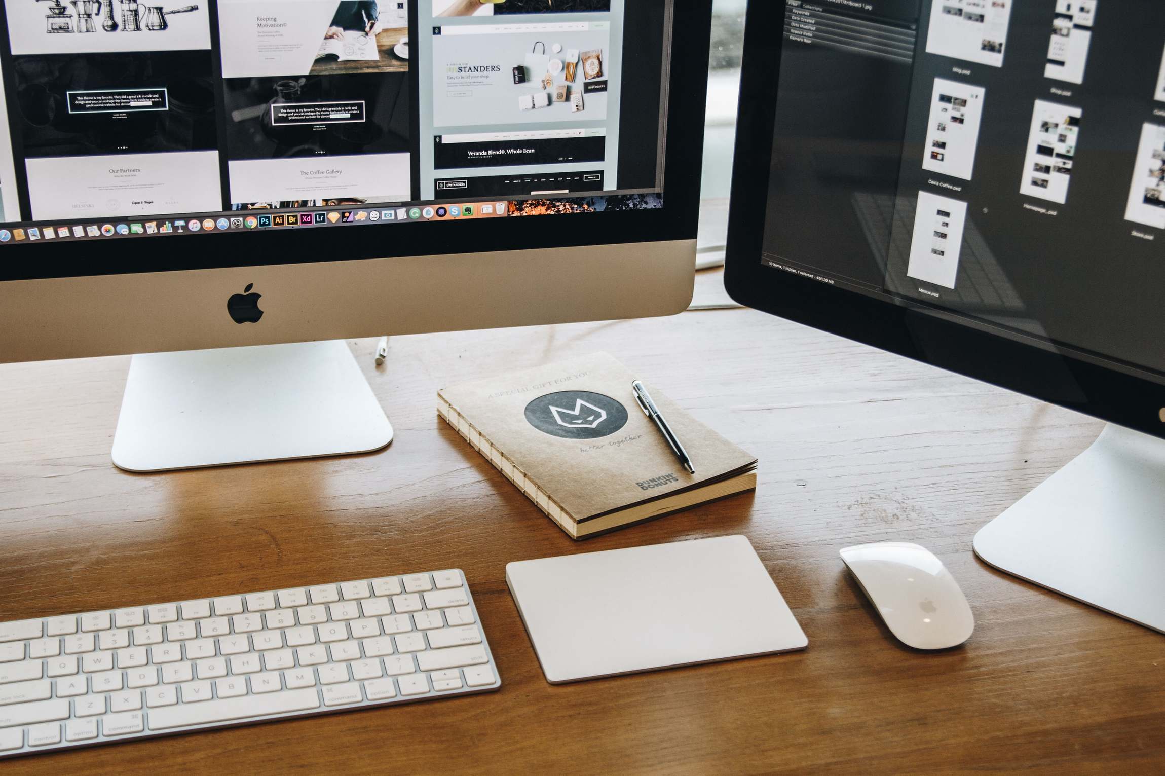 Minimalist desk setup with dual monitors, keyboard, and notebook for productivity